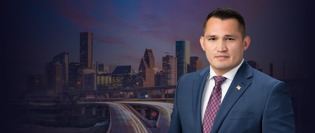 Picture of Art Aguilar with San Antonio buildings in the background